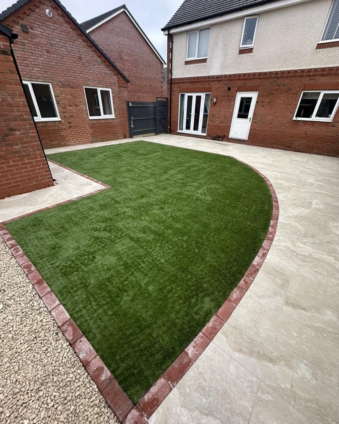 Curved lawn with brick edging and patio